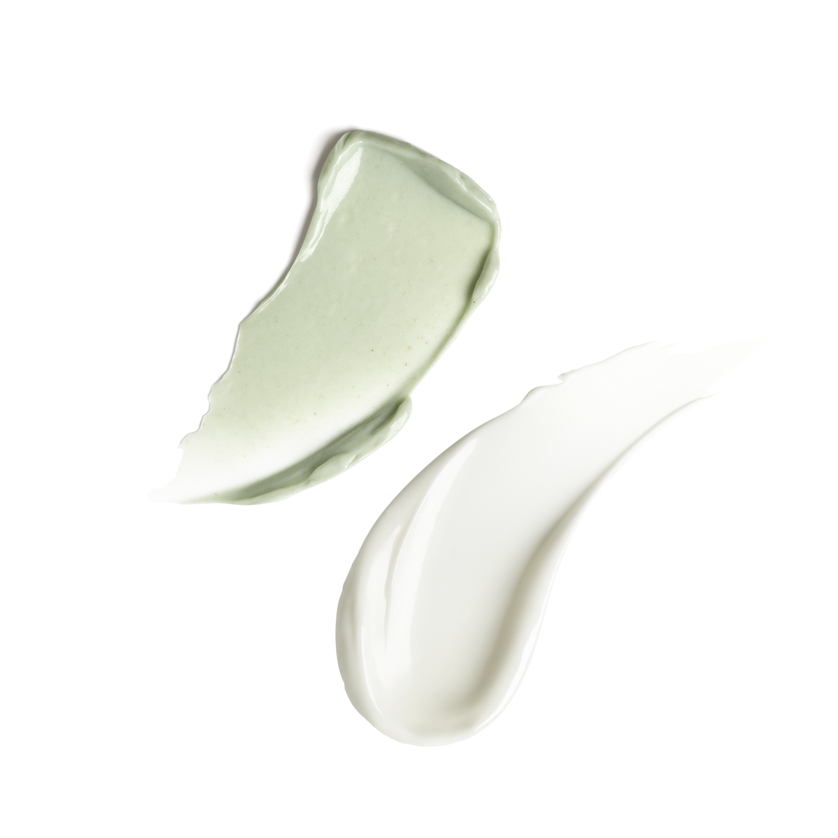 Two swatches of cream on a transparent background, one with a light mint green tint and one with a pure white color.