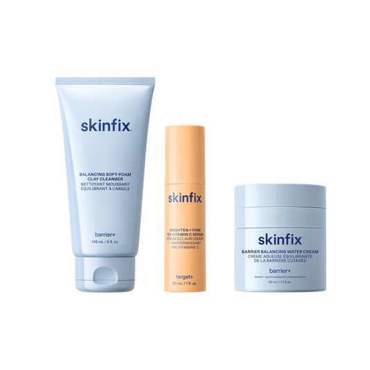Skinfix Balancing Soft-Foam Clay Cleanser (148 mL | 5 fl.oz.), Brighten + Firm 15% Vitamin C Serum (30 mL | 1 fl. oz.), and Barrier Balancing Water Cream (50 mL | 1.7oz), on a transparent background.