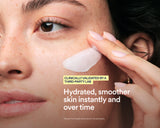Close-up of a woman applying a white cream or mask to her cheek, with text reading 'Hydrated, smoother skin instantly and over time' and a badge that says 'Clinically Validated by a Third-Party Lab.'.