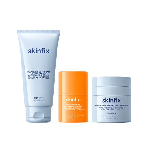Skinfix Balancing Soft-Foam Clay Cleanser (148 mL | 5 fl.oz.), Brighten + Firm 15% Vitamin C Serum (30 mL | 1 fl. oz.), and Barrier Balancing Water Cream (50 mL | 1.7oz), on a transparent background.