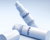 Three skincare pump bottles from the brand skinfix, all Triple Lipid Activating Serum bottles, arranged on a clean light blue gradient background.
