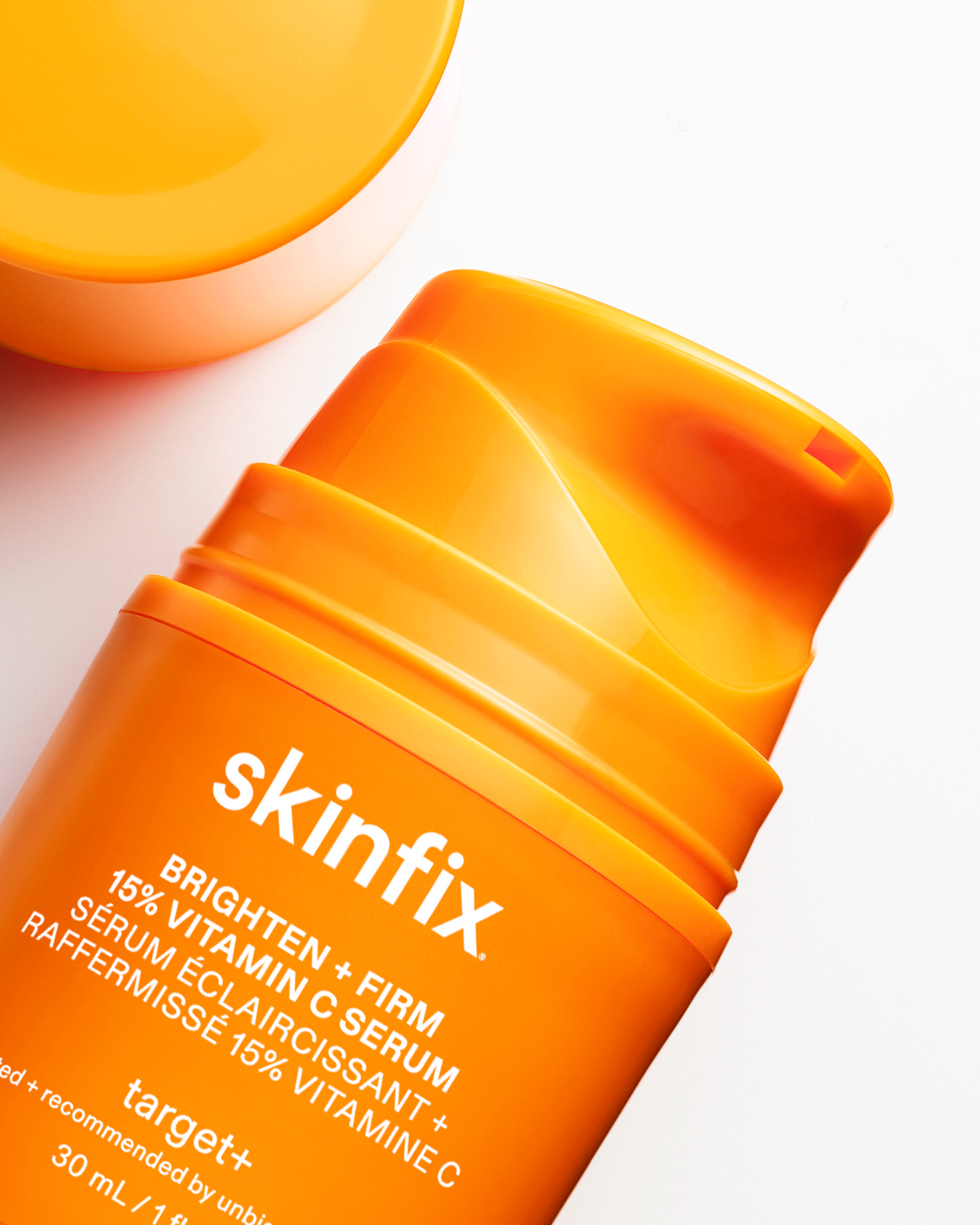Orange skincare serum bottle with 'skinfix' branding on a white background