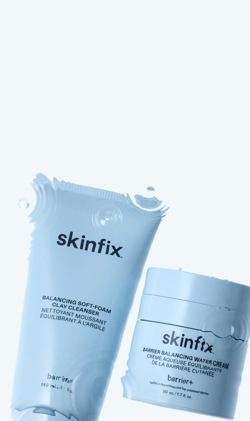 Skinfix Balancing Soft-Foam Clay Cleanser and Barrier Balancing Water Cream in light blue packaging, surrounded by water droplets and splashes, on a light blue background.